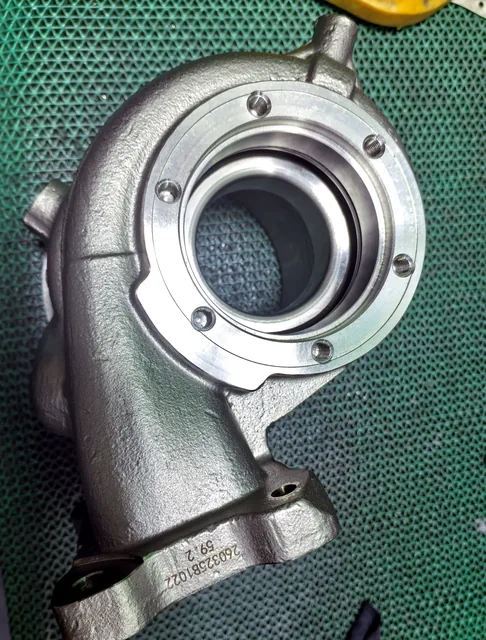 Machined bearing housing casting with circular mounting pattern and finished bore