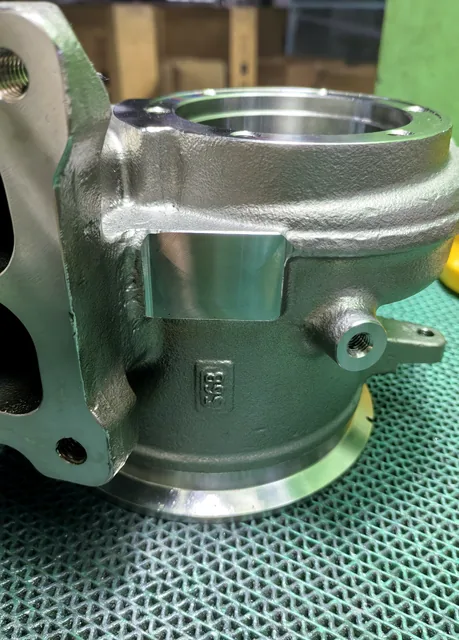 Close-up of precision machined bore and cast surface on a metal housing