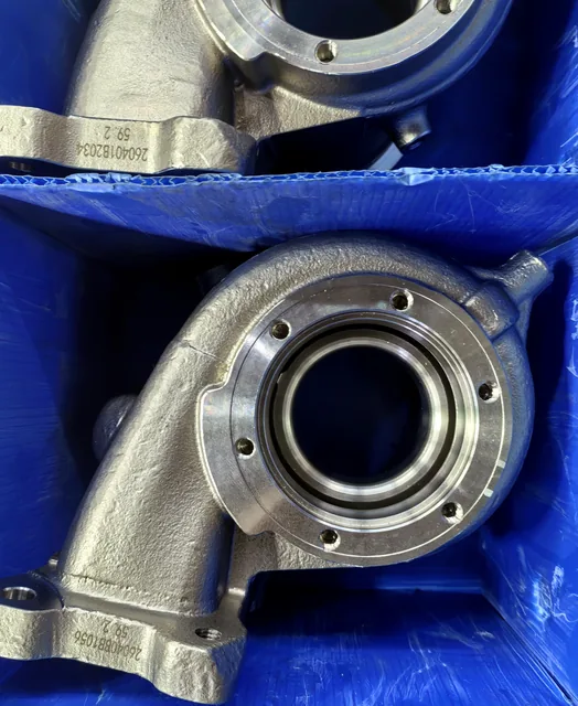 Finished machined casting housings packed for shipment in protective blue containers